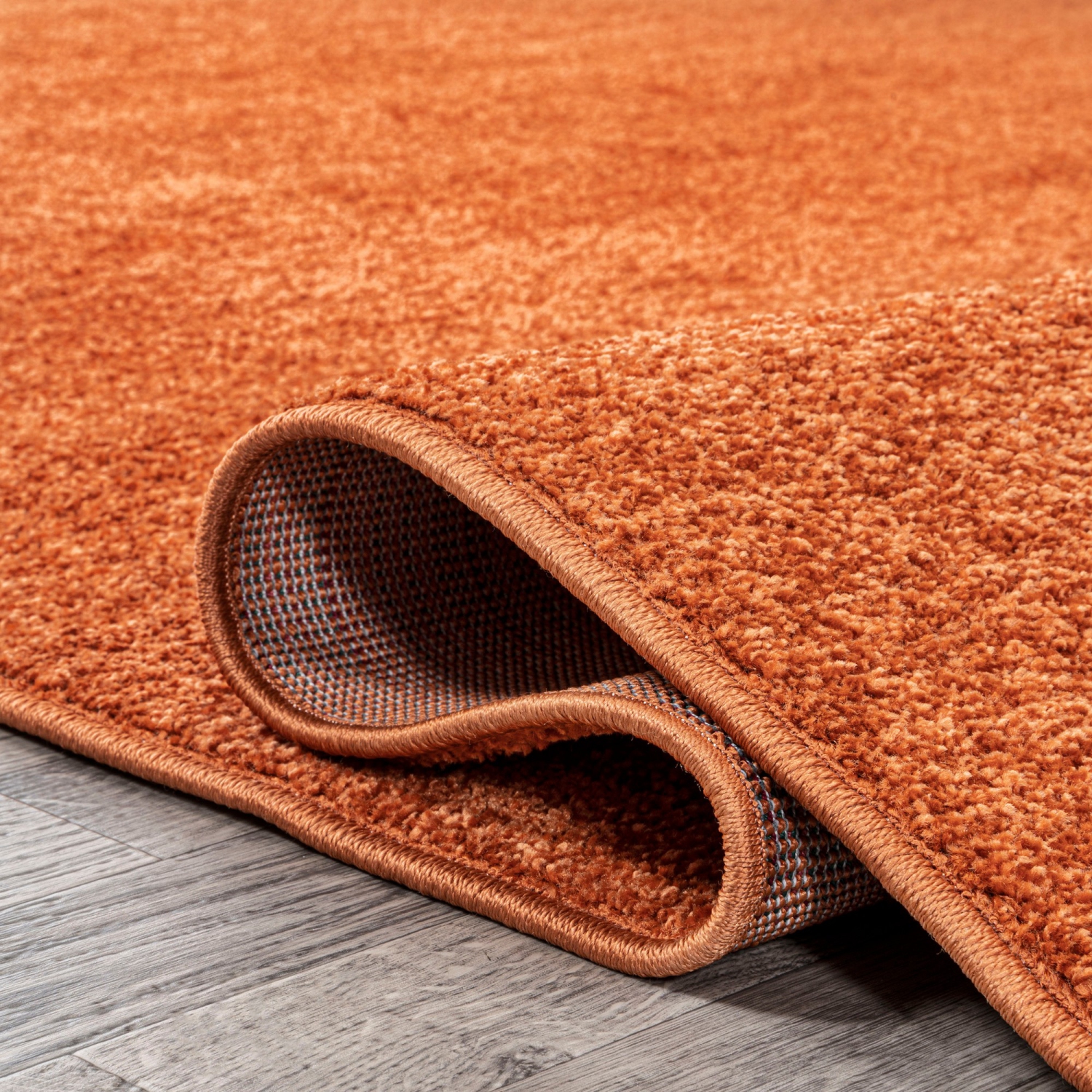 Haze Solid Low Pile Area Rug Orange