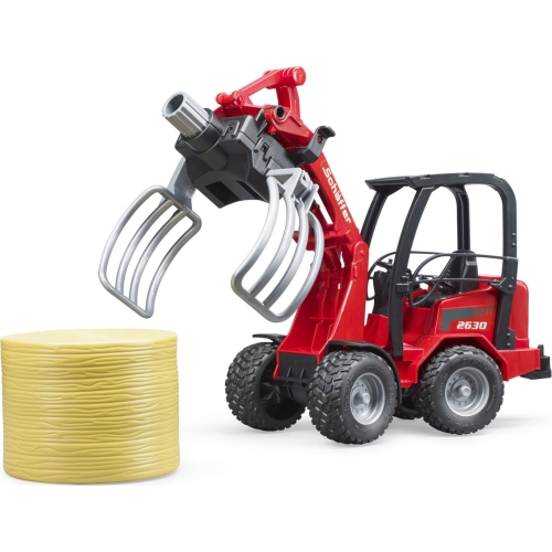 Schaeffer Compact loader 2630 with bale gripper and 1 round bale