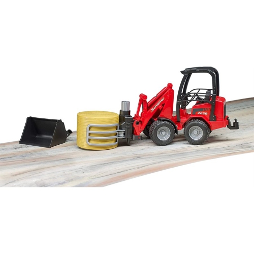 Schaeffer Compact loader 2630 with bale gripper and 1 round bale